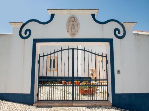 a gate in a wall with a caged iniction at Farmhouse in Montemor near Forest and Lake in Montemor-o-Novo
