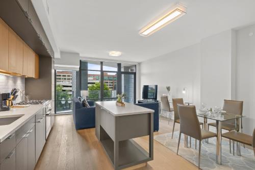 an open kitchen and dining room with a table and chairs at Global Luxury Suites at Tribeca in Washington