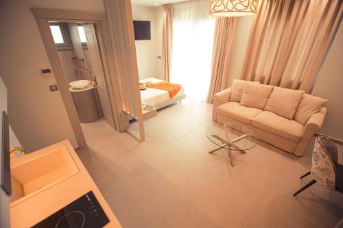 a living room with a couch and a chair at IO Luxury Pool & Hot Tub Suites in Preveza