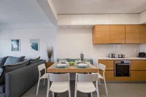 a kitchen and dining room with a table and chairs at Hermes&Dione in Argoulidhés