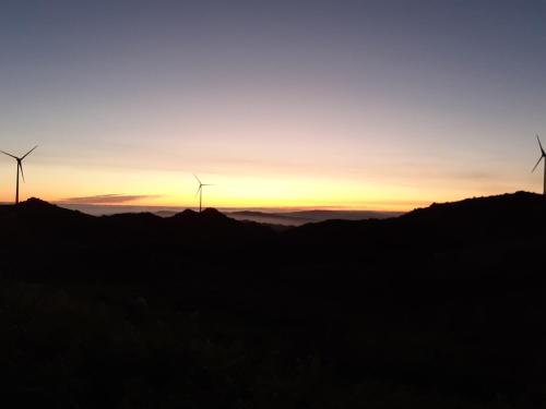 two windmills on a hill at sunset at Caramulo - Abrigo Serrano in Carvalhal da Mulher