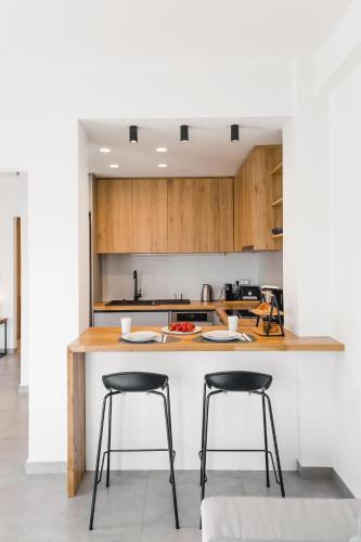 a kitchen with two bar stools at a counter at Hermes&Dione in Argoulidhés