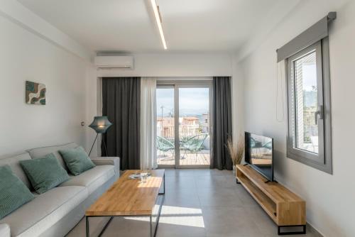 a living room with a couch and a table at Hermes&Dione in Argoulidhés