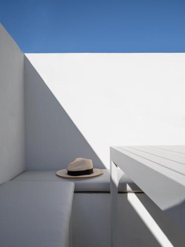 a hat sitting on a table in a white room at Hermes&Dione in Argoulidhés