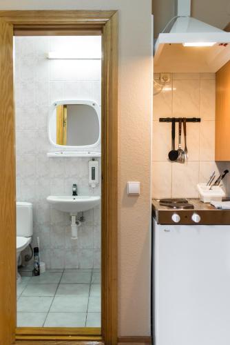 a small bathroom with a sink and a mirror at Abilana in Palanga