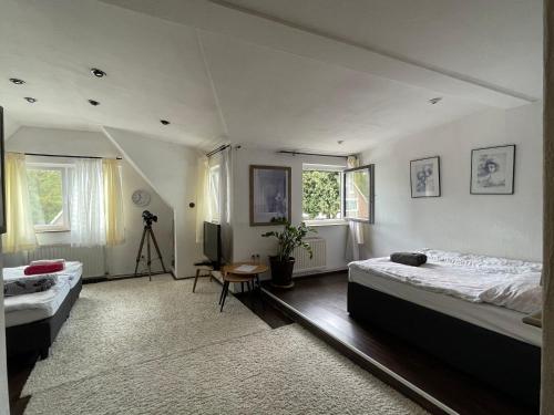 a bedroom with two beds and a tripod at Studio - HH Airport in Hamburg
