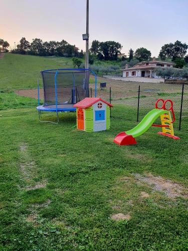 a playground with a slide and a play equipment at Casa Rosa in Elice