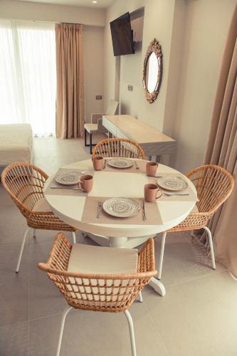 a white table and chairs in a living room at IO Luxury Pool & Hot Tub Suites in Preveza