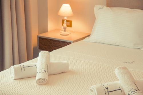 a hotel room with two towels on a bed at IO Luxury Pool & Hot Tub Suites in Preveza