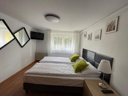 a bedroom with a large bed with green pillows at Apartament 2 pokoje 45m2 - 200 metrów od morza in Międzyzdroje
