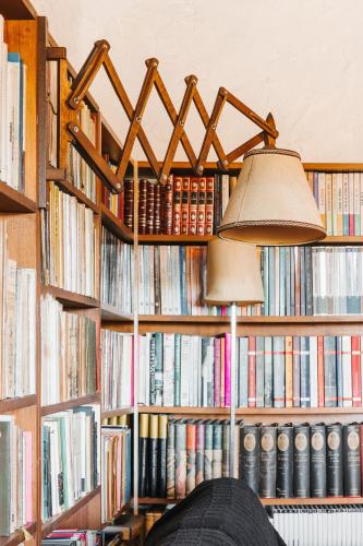 a book shelf filled with lots of books at Bird House in Lourinhã