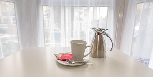 a coffee maker and a cup on a table at Beautiful 4 bedrooms house, 7 walk to train station in Plumstead