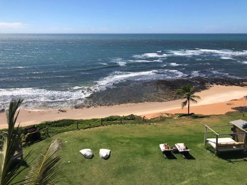 uma vista para uma praia com cadeiras e para o oceano em Kilombo Villas & Spa em Pipa