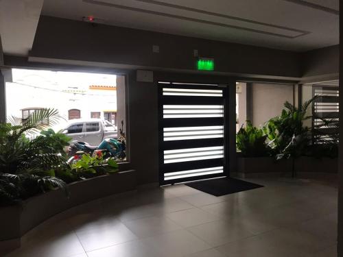 an open door to a parking garage with plants at salta centro in Salta