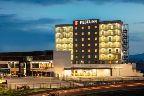 a hotel building with a sign on top of it at Fiesta Inn Guadalajara Aeropuerto in Guadalajara