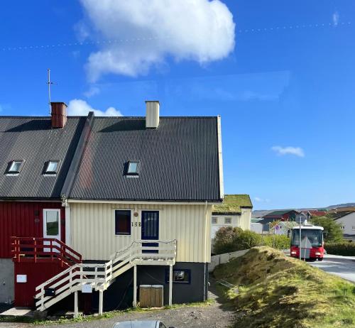 a house with a red and white house at Apartment in central Torshavn in Tórshavn