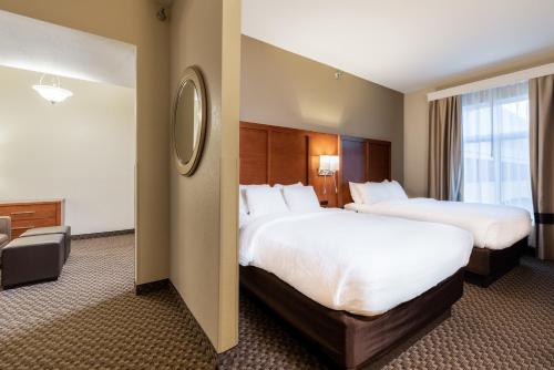 a hotel room with two beds and a window at Comfort Suites Troy-I75 in Troy