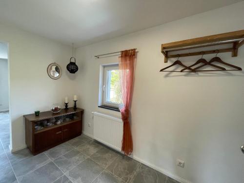 a living room with a window and a tiled floor at Maharaja Ferienhaus in Hemfurth-Edersee