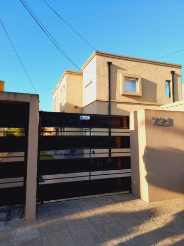 a gate to a house with a fence at FINCA NOVA Apartment 6 in Balcarce