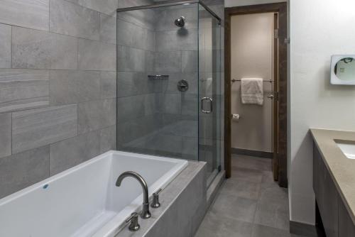 a bathroom with a tub and a shower at Grand Colorado on Peak 8 in Breckenridge