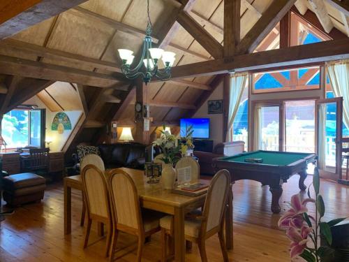 a living room with a table and a pool table at Owl Street Lodge in Hope