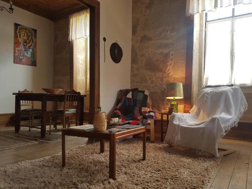 a living room with a couch and a table at Casa da Vila in Penamacor