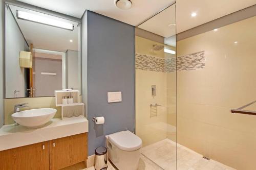 a bathroom with a sink and a toilet and a shower at Canal Quays 606 in Cape Town