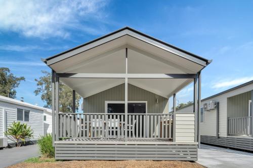 a screened in porch of a manufactured home with a roof at Ingenia Holidays Middle Rock in One Mile