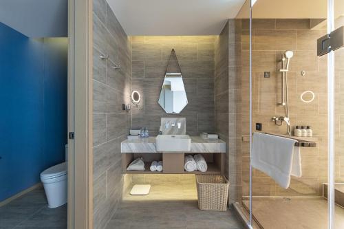 a bathroom with a sink and a shower at Atour Hotel Xian Economic Development Zone Fengcheng 5th Road in Xi'an