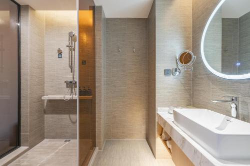 a bathroom with a sink and a shower at Atour Hotel Kunshan Baoyu Plaza North Changjiang Road in Kunshan