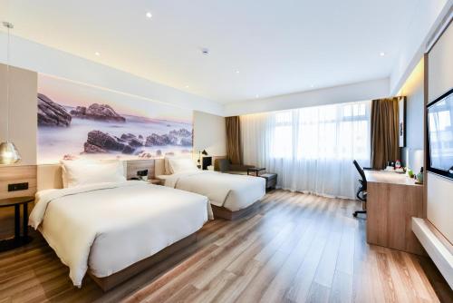 Ένα ή περισσότερα κρεβάτια σε δωμάτιο στο Atour Hotel Qinghuangdao Shanhaiguang