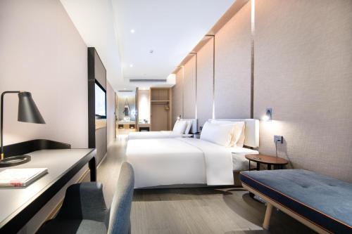 Tempat tidur dalam kamar di Atour Hotel Yuzhong Yuci Incity