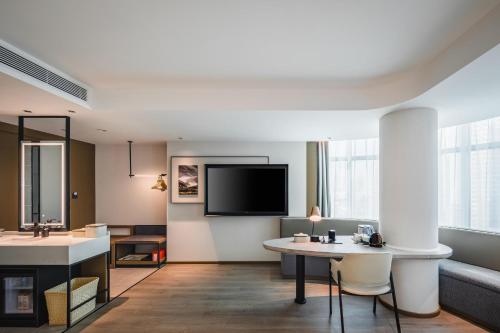 a living room with a couch and a table at Atour Hotel Shenyang Changbai Island in Shenyang