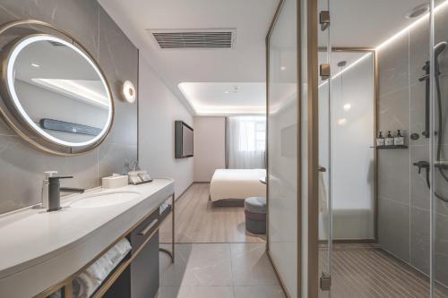 a bathroom with a sink and a mirror at Atour Light Hotel Nantong Drum Plaza South Street in Nantong