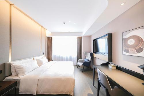 Ένα ή περισσότερα κρεβάτια σε δωμάτιο στο Atour Hotel Luoyang Yingtianmen