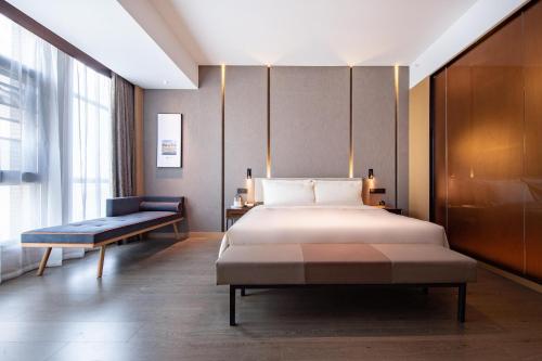 A bed or beds in a room at Atour Hotel Kunming City Government Xishan Dianchi Lake
