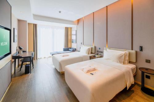 Postel nebo postele na pokoji v ubytování Atour Hotel Huizhou Zhongkai Tianyi
