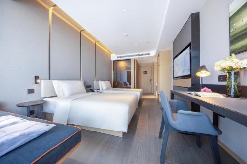 Ένα ή περισσότερα κρεβάτια σε δωμάτιο στο Atour Hotel Jincheng Development Lanhua Road