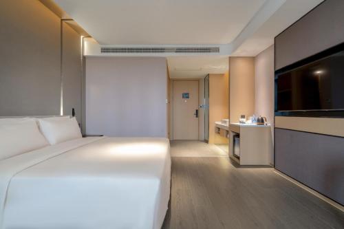 Ένα ή περισσότερα κρεβάτια σε δωμάτιο στο Atour Hotel Yixing Middle Yangquan Road