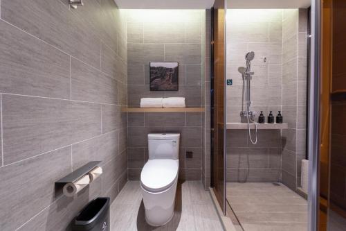 a bathroom with a toilet and a shower at Atour Hotel Sanhe Yanjiao Development District in Sanhe