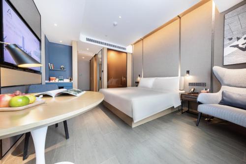 a hotel room with a bed and a desk at Atour Hotel Nanjing Drum Town Qingliang Gate in Nanjing