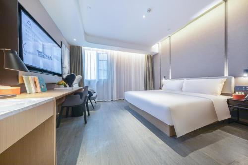 Ένα ή περισσότερα κρεβάτια σε δωμάτιο στο Atour Hotel Nanjing Xianlin Unviersity Town