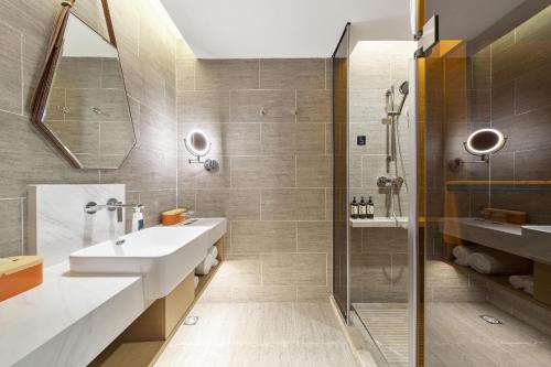 a bathroom with a sink and a shower at Atour Hotel Ya an Era Street in Ya'an