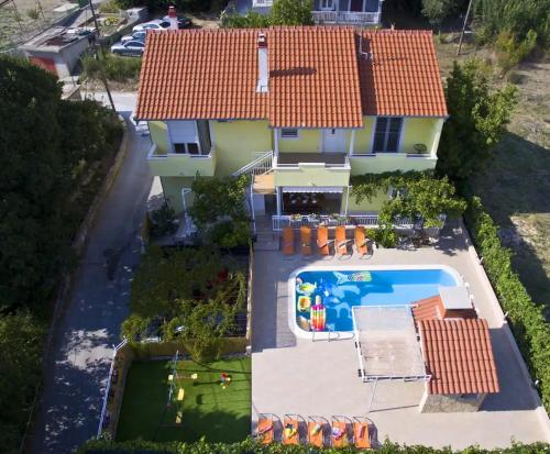 an aerial view of a house with a swimming pool at Beautiful villa - private heated pool, parking, BBQ near Split in Solin
