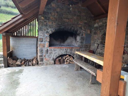 a stone fireplace with a bench in front of it at Holiday home in Semic Kranjska Krain 42896 in Semič