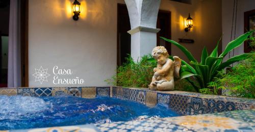 a statue of a dog sitting next to a swimming pool at Casa Ensueño Hogar Boutique in Guaduas