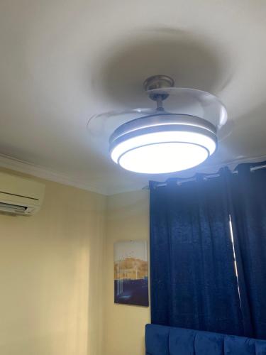 a ceiling light in a room with a blue curtain at Casa Apartamento Valentina in Santo Domingo