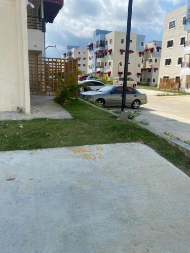 a parking lot with a car parked next to a building at Casa Apartamento Valentina in Santo Domingo