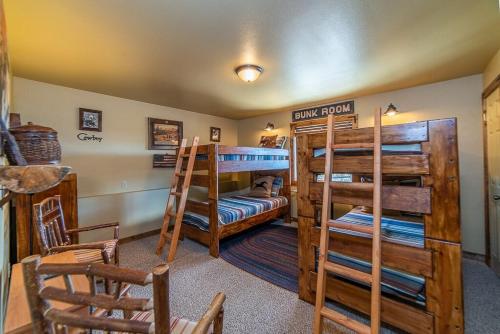 a room with two bunk beds and a sitting area at Relax and Unwind with Breathtaking Panoramic Views - Red Hill House in Fairplay