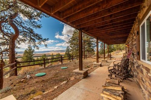 a porch of a house with a tree and frisbees at Relax and Unwind with Breathtaking Panoramic Views - Red Hill House in Fairplay